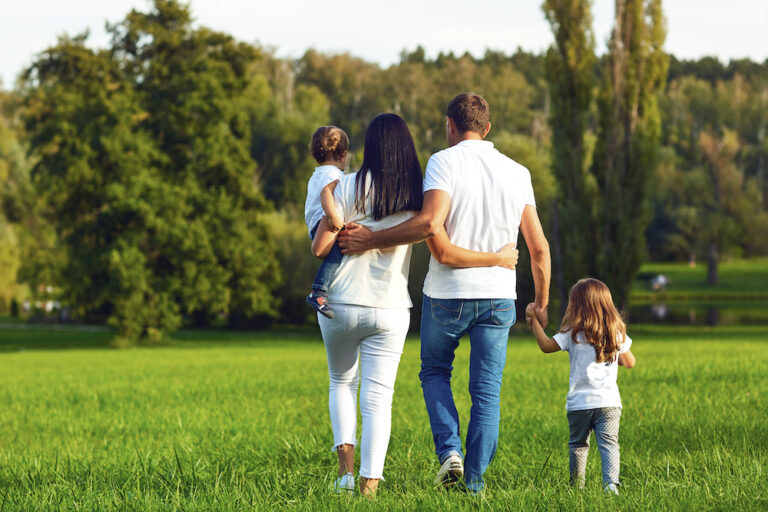 family walking grass