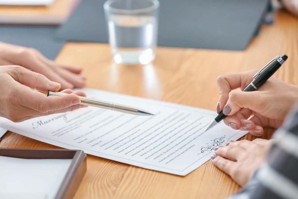 hands signing document